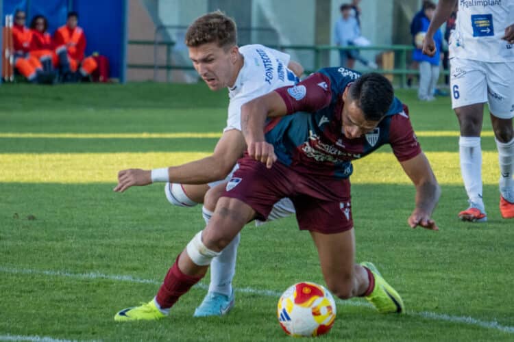 Álex Castro pugna con un rival durante un instante de partido entre Segoviana Sarriana./HÉCTOR CRIADO