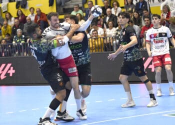 David Fernández pugna con dos rivales en un instante de partido entre BM Nava y Torrelavega./AMADOR MARUGÁN